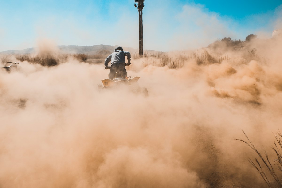 Worker abrasive blasting in a dust cloud